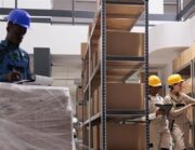 Warehouse team checking shipping documents and scanning parcels before dispatch, illustrating export preparation for Bulgarian businesses.